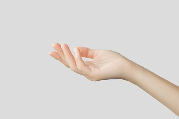 female hand holding something invisible on gray background