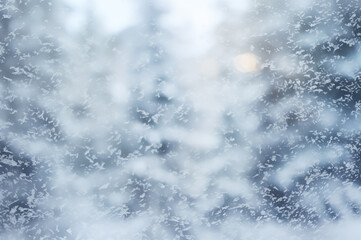 Winter background. View through the window on Christmas evening in winter