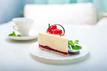 delicious piece of cheesecake and white cup