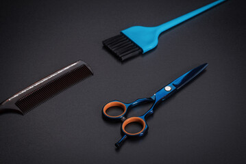Hairdressing tools on a black background.