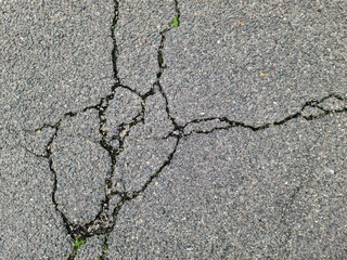Asphalt surfaces of different streets and roads with cracks in close up