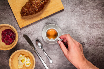 Good morning, table ready for breakfast. Espresso coffee, croissant, butter, jam and cutlery.