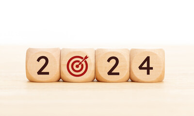 2024 business goals concept. Wooden blocks with 2024 number and goal target icon. Copy space