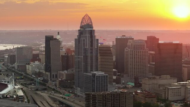 Downtown district of Cincinnati in Ohio, USA at sunset with brightly illuminated high skyscraper buildings. American travel destination