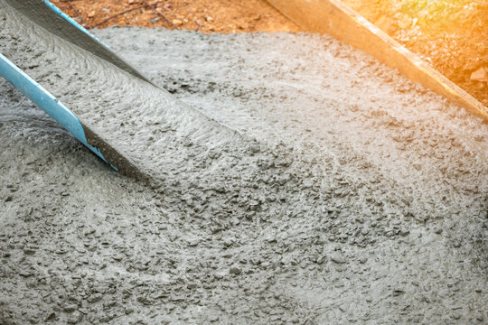 Mixer track pouring wet cement to the civil building foundation