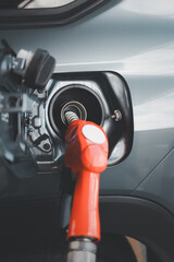 Refilling and pumping gasoline oil the car with fuel at the refuel station. Car refueling on a...