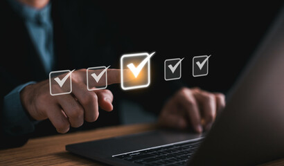 Checklist concept, Businessman working on laptop computer checklist and filling survey form online...
