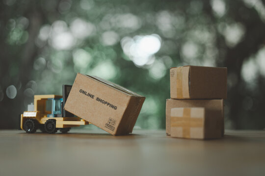 Cardboard box on yellow forklift order from shopping online. Package box to the recipient to arrive at home
