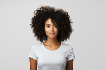 Young happy african american woman in white t-shirt isolated on white background