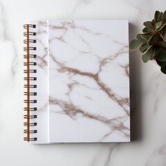 white and square notebook on a marble background