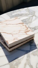 white and square notebook on a marble background