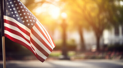 An American flag waving proudly in the wind at a veterans memorial, with copy space, blurred background