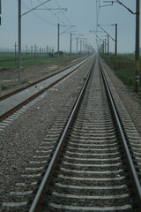 Fototapeta na wymiar A sleek train track stretches across vast open plains
