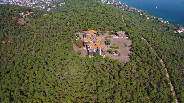 Buyukada, Istanbul. The drone circles around the orphanage in Buyukada. Magnificent tree and sea view. Orphanage building surrounded by dense trees.Istanbul,Turkey.