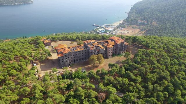 Buyukada, Istanbul. A drone is flying around the old, dilapidated orphanage on Buyukada. Magnificent tree and sea view.  Istanbul Turkey