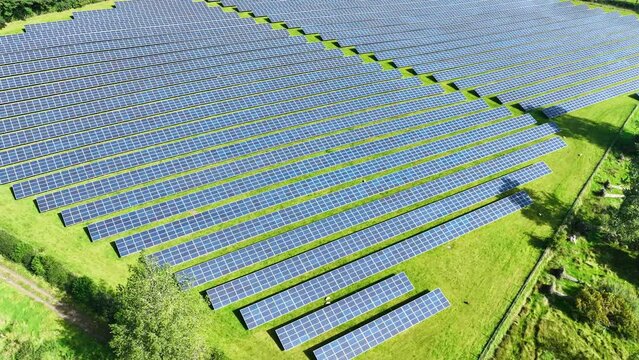 Aerial video of Solar PV panels on a Solar Farm generating renewable electric energy 