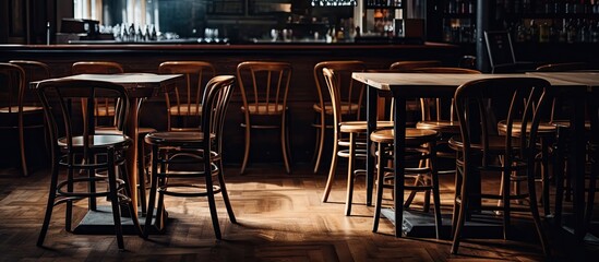Tables with stacked chairs and stools in an empty closed restaurant amid the Covid 19 pandemic