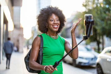 Beautiful woman taking selfie with mobile phone in the city
 - obrazy, fototapety, plakaty