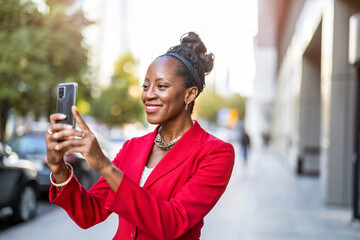 Fototapeta na wymiar Portrait of smiling mature businesswoman using mobile phone in urban setting 