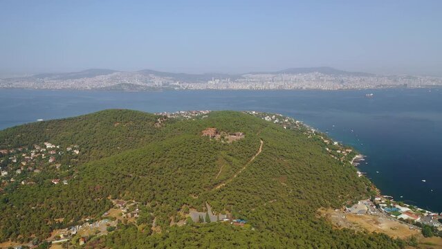 Buyukada, Istanbul. A drone is flying around the old, dilapidated orphanage on Buyukada. Magnificent tree and sea view. The building is currently demolished. Istanbul Turkey