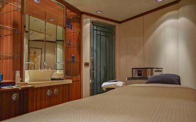 Welcome desk and relaxation massage therapy rooms inside spa thermal wellness suite onboard luxury...
