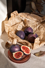 Ripe fig fruits on lifestyle messy kitchen table, aesthetic sustainable autumn still life