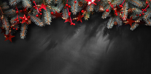 Christmas Decoration With Fir Branches And Red Stars On A Dark Background