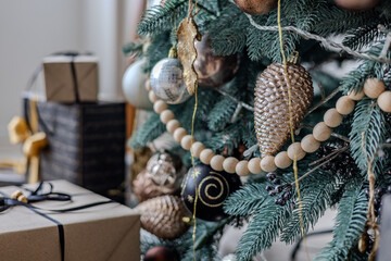 Multicolored Christmas tree decorations, close-up of a Christmas tree with garlands and glass balls.