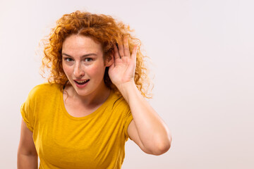 Image of surprised ginger woman listening something.