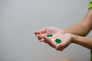 woman holding pills in hand preparing for use The concept of taking care of one’s health and helping people in the house,shotlisthealth