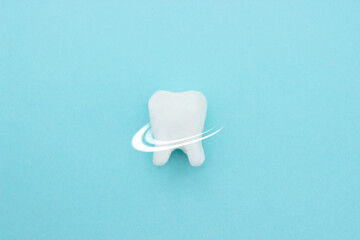 Protective vortex around tooth model on blue , teeth will good healthy.