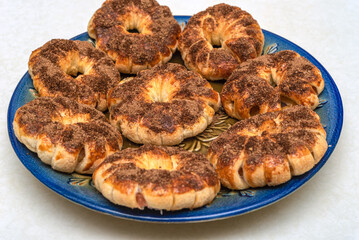 Delicious baked apples in dough with cinnamon on a blue plate.