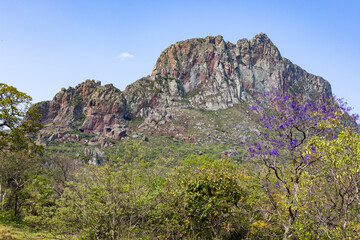 Exploring the Serrania de Chochis with the gigantic reddish rock formation Torre de David near the picturesque village Chochis near Santa Cruz de la Sierra in Bolivia - Traveling South America