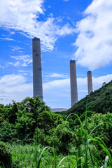 The view of Industrial chimneys at Lamma Island, Hong Kong, China under the blue sky with Lotus plant. Travel scene and nature scene.