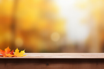 Naklejka na ściany i meble Tree orange maple leaves on a wooden table with copy space on a blurred yellow background.