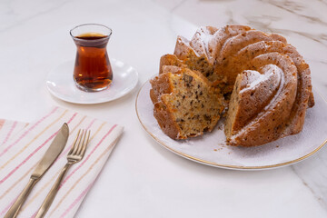 Carrot cake with tea on white marble floor