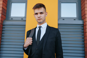 Amidst the hustle and bustle of the business world, a young Caucasian American man in a business...