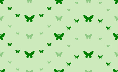 Seamless pattern of large and small green butterfly symbols. The elements are arranged in a wavy. Vector illustration on light green background