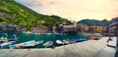 A panoramic view of a small fishing town of Vernazza and Church of St. Margaret of Antioch in the famous Cinque Terre region in Italy