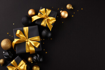Immerse yourself in a magical holiday atmosphere. Top view flat lay of festive presents with golden bows, xmas balls, star-shaped confetti on black background with advert space