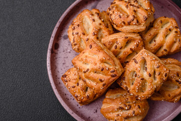 Delicious crispy mini puffs with sausage or meat with salt, thyme and sesame