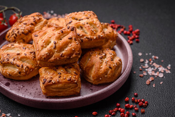 Delicious crispy mini puffs with sausage or meat with salt, thyme and sesame