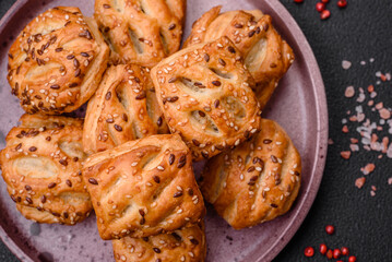 Delicious crispy mini puffs with sausage or meat with salt, thyme and sesame
