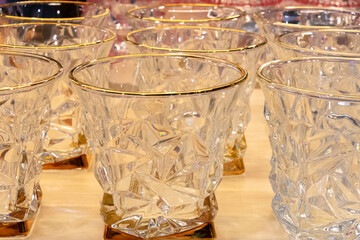 A row of glass crystal glasses with beautiful edges.