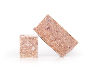 Staked frozen meat blocks. Raw food diet or barf for dogs, cats and pets. Organic human grade ground chicken with muscle, bone and organs for large dog feeding. White background. Selective focus.