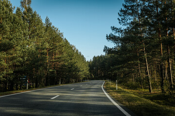 Obraz premium Riga - Valmiera asphalted new road. Road traffic on Latvian roads. Road with asphalt coating. Heavy and light vehicle movement.