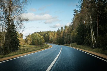Riga - Valmiera asphalted new road. Road traffic on Latvian roads. Road with asphalt coating. Heavy and light vehicle movement.