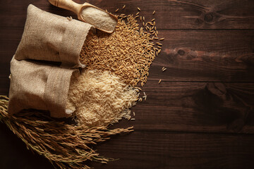Different stages of organic Rice (Oryza sativa) spilled out from the jute bag. Rice Bran, Rice, and...