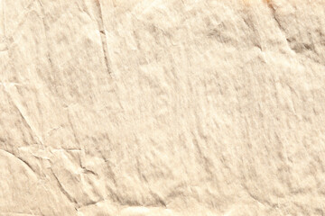Beige crumpled paper texture with grains macro closeup