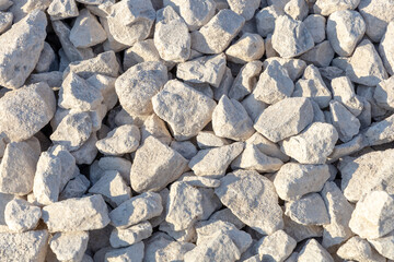 Crushed stone, building material texture, full frame. Bulk material for the construction of roads, roadways, pipe laying and utilities. Close-up